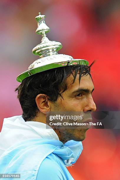 Carlos Tevez of Man City celebrates with the trophy after the The FA Cup sponsored by E.0N 2011 Final match between Manchester City and Stoke City at...