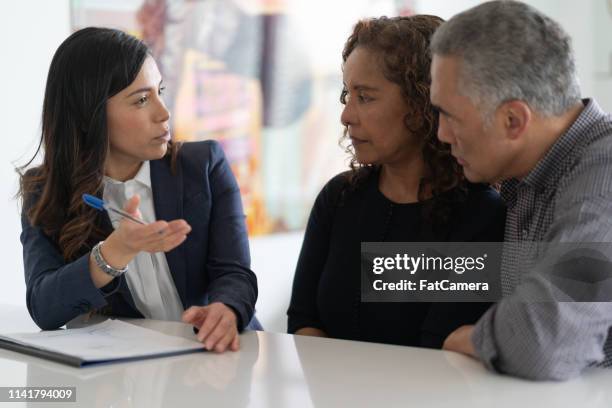 ethnic senior couple with financial advisor - medical savings stock pictures, royalty-free photos & images