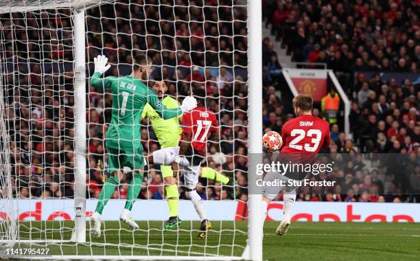 Header from Barcelona striker Luis Suarez deflects off United player Luke Shaw for the first Barcelona goal during the UEFA Champions League Quarter...