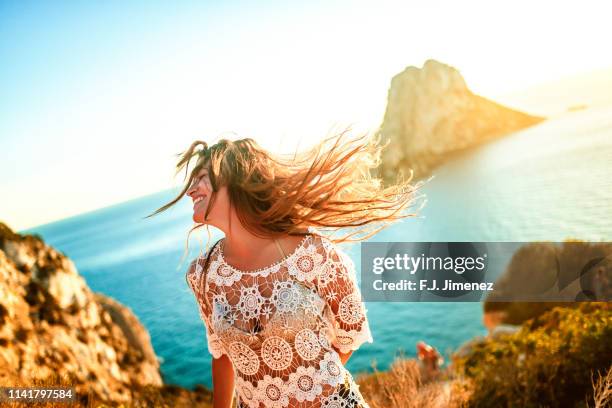 woman with es vedra in the background, ibiza, spain. - ibiza foto e immagini stock