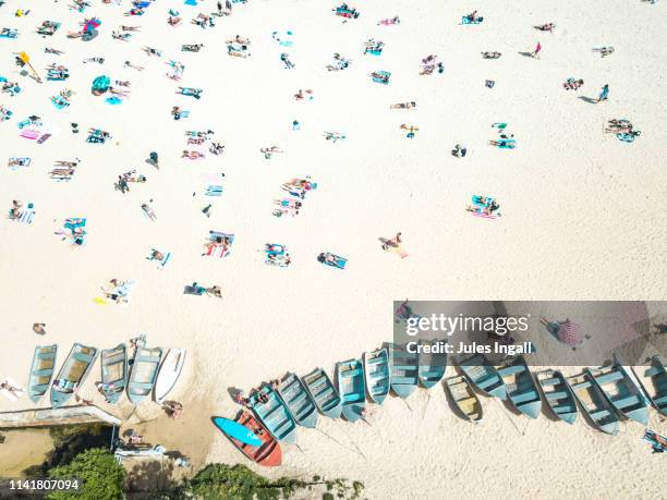 aerial drone view of beach with abandoned boats - coogee stock-fotos und bilder