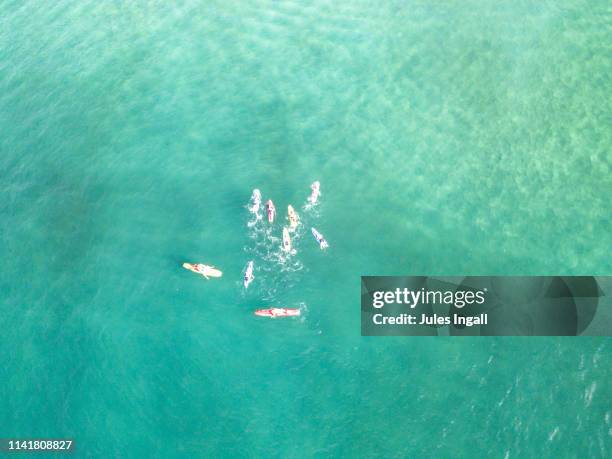 aerial view of the beach and surf with paddle boarders - paddleboarding australia stock pictures, royalty-free photos & images