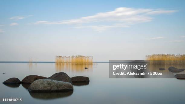 the blue sky is reflected ladoga lake in evening - lake ladoga stock pictures, royalty-free photos & images