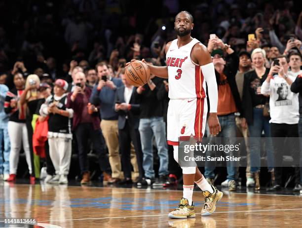 Dwyane Wade of the Miami Heat dribbles the ball in the final seconds of the second half of the game against the Brooklyn Nets at Barclays Center on...