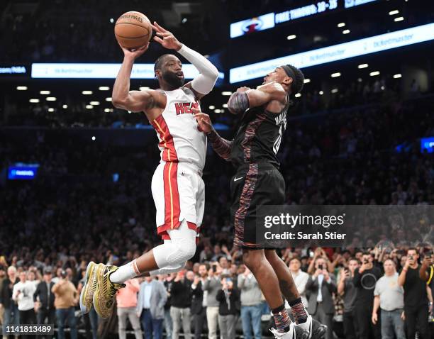 Dwyane Wade of the Miami Heat passes the ball in the final seconds of the game against the Brooklyn Nets at Barclays Center on April 10, 2019 in the...
