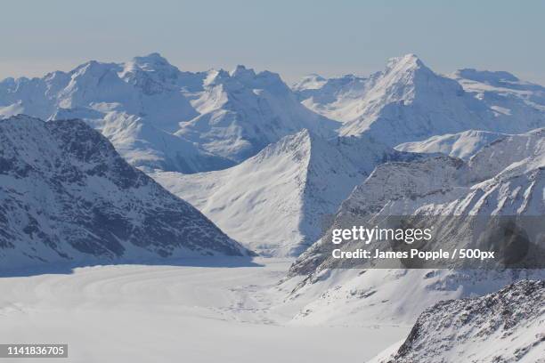 landscape of snowcapped mountains - james popple stock-fotos und bilder