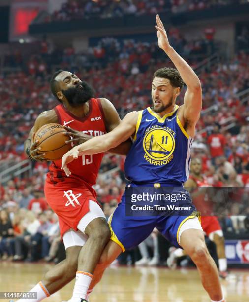 James Harden of the Houston Rockets drives to the basket defended by Klay Thompson of the Golden State Warriors in the first half during Game Four of...