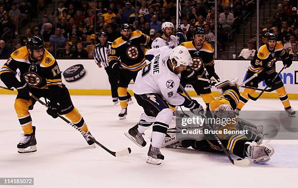 Tim Thomas of the Boston Bruins makes a second period save against Steve Downie of the Tampa Bay Lightning in Game One of the Eastern Conference...