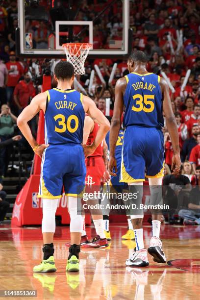 Stephen Curry and Kevin Durant of the Golden State Warriors look on against the Houston Rockets during Game Four of the Western Conference Semifinals...