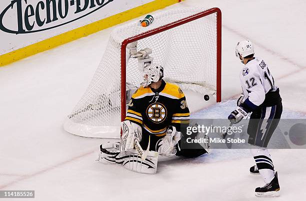Simon Gagne of the Tampa Bay Lightning watches his third period goal pass Tim Thomas of the Boston Bruins in Game One of the Eastern Conference...