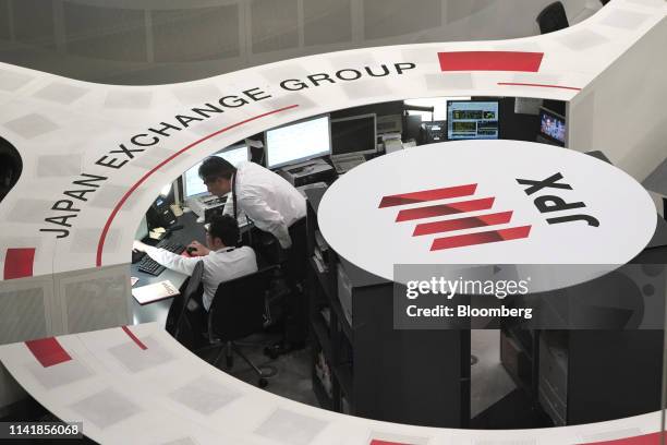 Employees work at the Tokyo Stock Exchange , operated by Japan Exchange Group Inc. , in Tokyo, Japan, on Tuesday, May 7, 2019. Trading resumed...