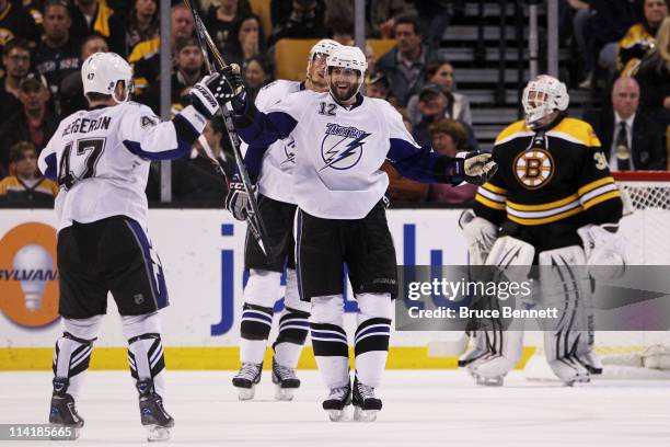 Marc-Andre Bergeron celebrates his third period powerplay goal with Simon Gagne of the Tampa Bay Lightning during Game One of the Eastern Conference...