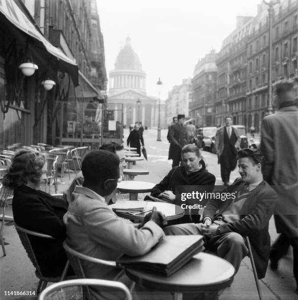 Group of students have a drink on a cafe terrace rue Soufflot, near the Sorbonne university in February 1950, in Paris.