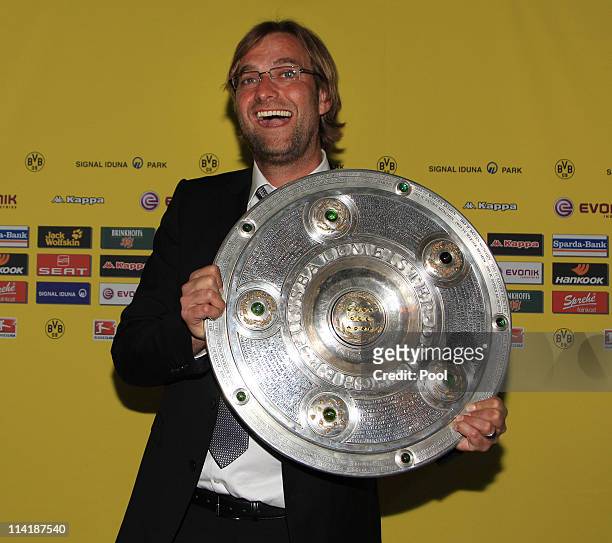 Head coach Juergen Klopp poses with the German Championship trophy during the dinner to celebrate their German Bundesliga 2010/2011 victory on May...