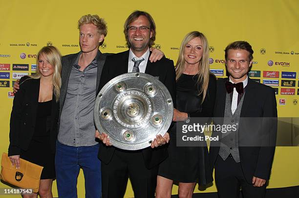 Head coach Juergen Klopp , his wife Ulla Klopp , his son Marc Klopp , Ulla's son and his girlfriend pose with the German Championship trophy during...