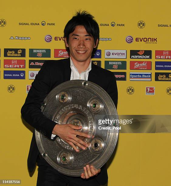 Shinji Kagawa poses with the German Championship trophy during the dinner to celebrate their German Bundesliga 2010/2011 victory on May 14, 2011 in...