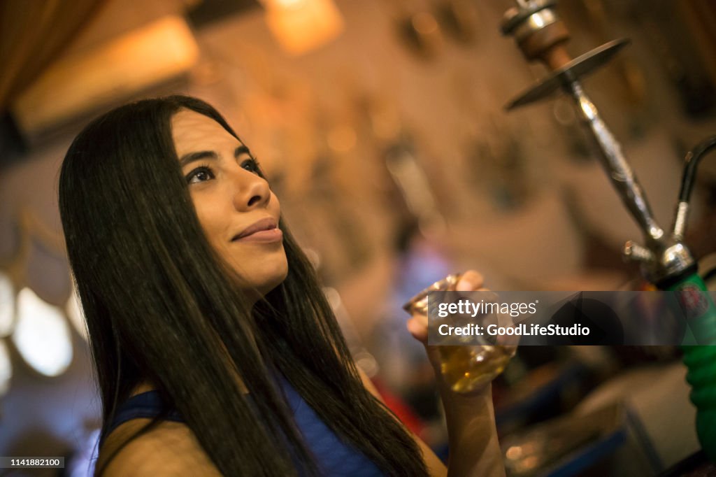 Young Egyptian woman drinking tea