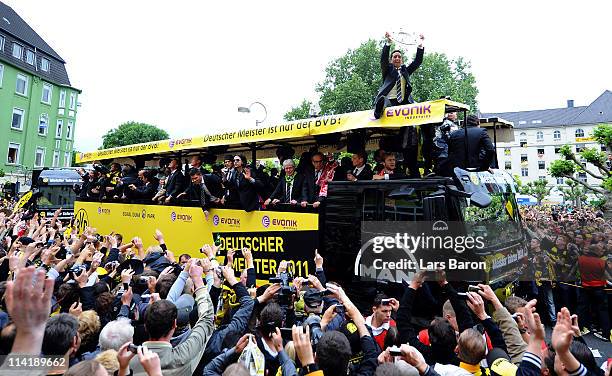 Lucas Barrios lifts the trophy and celebrates winning the German championship with team mates and fans during the Borussia Dortmund Bundesliga...