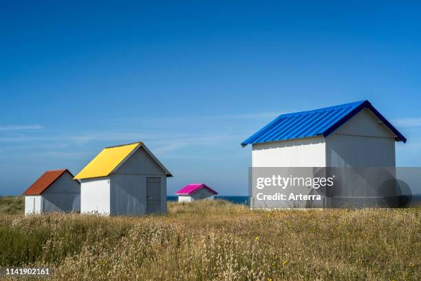 Row of colourful beach cabins in the dunes at Gouville-sur-Mer, Lower Normandy, France.