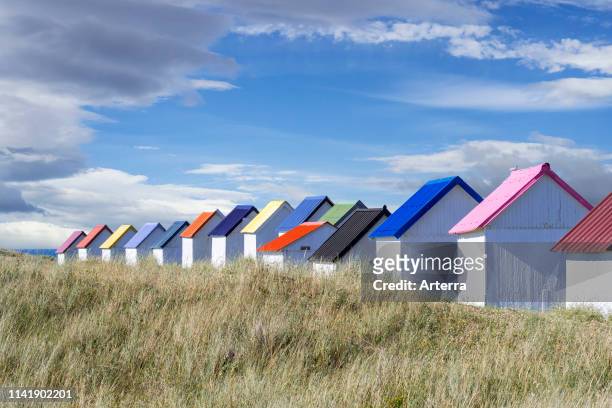 Row of colourful beach cabins in the dunes at Gouville-sur-Mer, Lower Normandy, France.