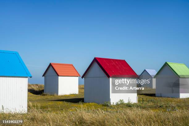 Row of colourful beach cabins in the dunes at Gouville-sur-Mer, Lower Normandy, France.