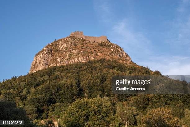 Ruins of the medieval Chateau de Montsegur castle on hilltop at sunset, stronghold of the Cathars in the Ariege department, Occitanie, France.