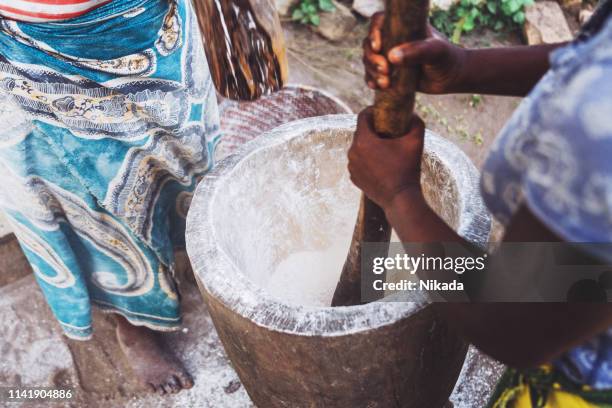 african women at work, mashing cassava flour in wooden pod - tapioca stock pictures, royalty-free photos & images