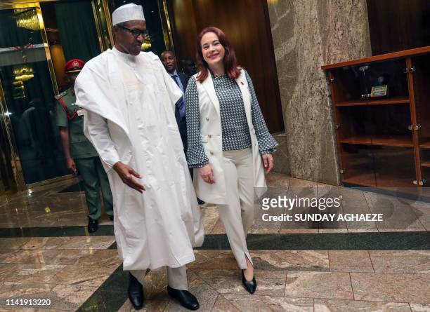 The President of the United Nations General Assembly Maria Fernanda Espinosa walks with Nigerian President Mohammadu Buhari upon her arrival at the...