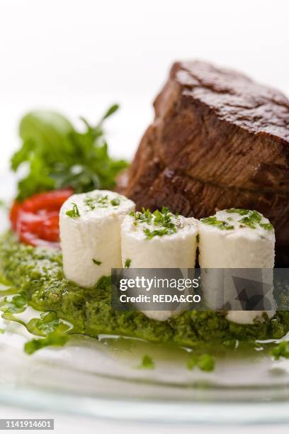 Beef roasted on green sauce with fresh cheese Beef roasted on green sauce with fresh cheese. Italy. Europe.