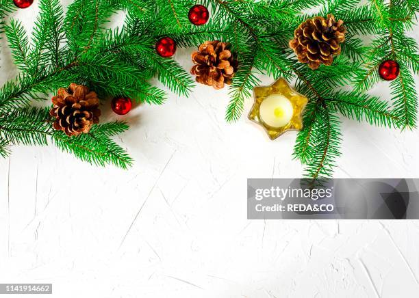 Christmas holiday background with fir branches. Pine cones and ornaments. Winter holiday concept composition. Copy space.