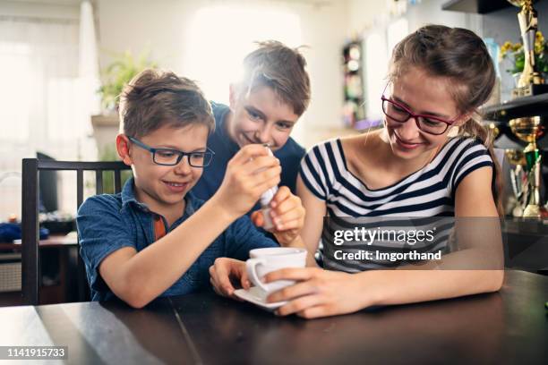 kids playing an april fools day prank - april fools day imagens e fotografias de stock