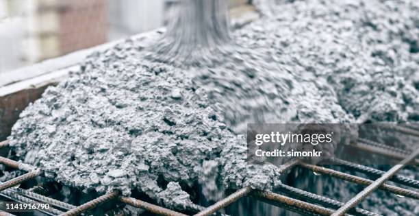cement pouring on metal rod - cement stock pictures, royalty-free photos & images