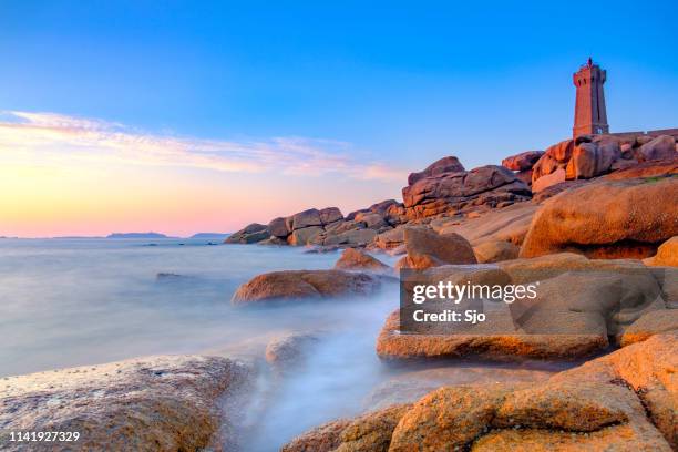 ploumanach lighthouse at the pink granite coast in brittany, france during sunset - brittany france stock pictures, royalty-free photos & images