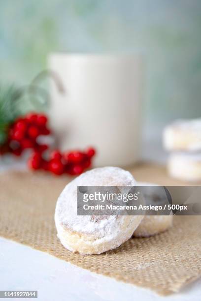 close-up christmas spanish sweets and a mug polvoronestif - polvorón stock pictures, royalty-free photos & images