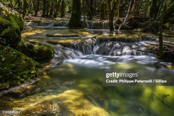 small waterfall at the source of the river huveaun - cascade france stock pictures, royalty-free photos & images