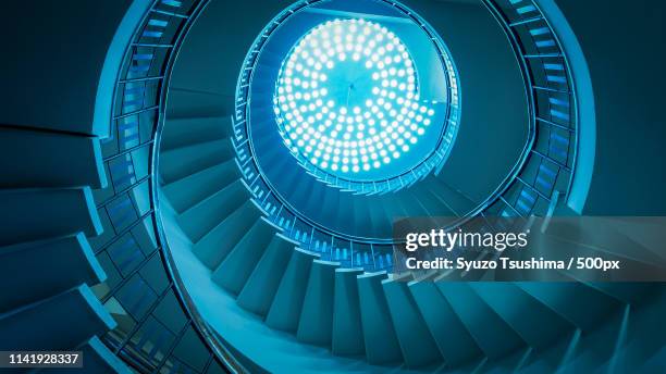 view from below of spiral staircase - spiral staircase fotografías e imágenes de stock