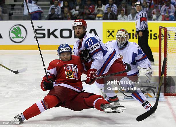 Marek Zidlicky of Czech Republic struggles against Vitali Atyushov of Russia during the IIHF World Championship bronze medal match between Czech...