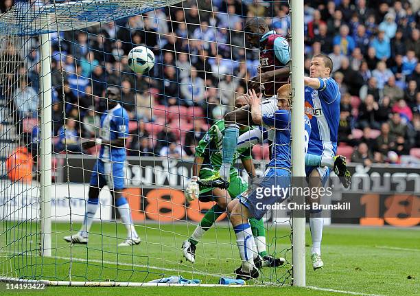 Demba Ba of West Ham scores his team's second goal during the Barclays Premier League match between Wigan Athletic and West Ham United at the DW...