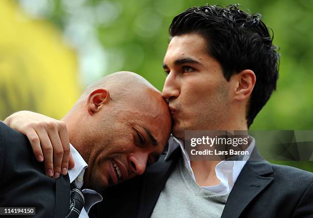 Dede cries in the arms of team mate Nuri Sahin on the stage during the Borussia Dortmund Bundesliga winners parade at Westfalenhalle on May 15, 2011...