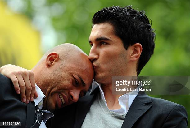 Dede cries in the arms of team mate Nuri Sahin on the stage during the Borussia Dortmund Bundesliga winners parade at Westfalenhalle on May 15, 2011...
