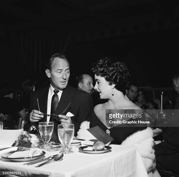 British-American actress, businesswoman, and humanitarian Elizabeth Taylor and English actor Michael Wilding attend the premiere of 'Lili', US, March...