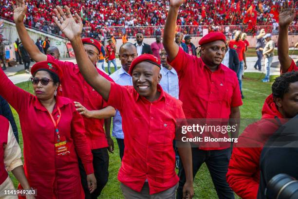 Julius Malema, leader of the Economic Freedom Fighters , center, waves to the crowd during an Economic Freedom Fighters party campaign rally in...