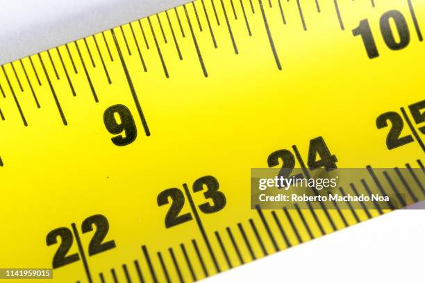 yellow measuring tape over white background - measuring tape stockfoto's en -beelden