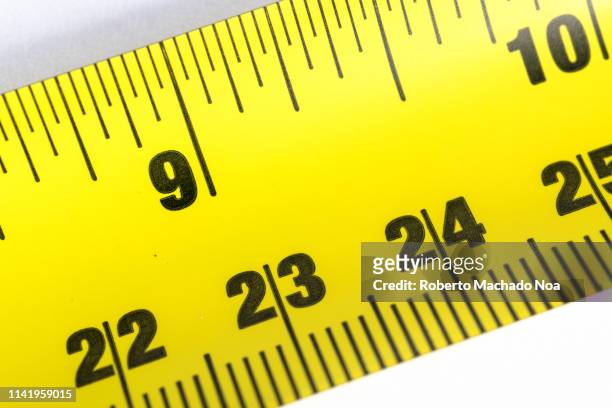 yellow measuring tape over white background - metric system stock pictures, royalty-free photos & images