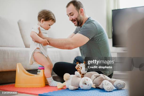 father training his child to use potty - men taking a dump stock pictures, royalty-free photos & images