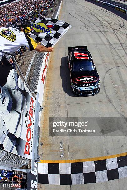 Matt Kenseth, driver of the Wiley X Sunglasses Ford, crosses the finish line to win the NASCAR Sprint Cup Series FedEx 400 Benefiting Autism Speaks...