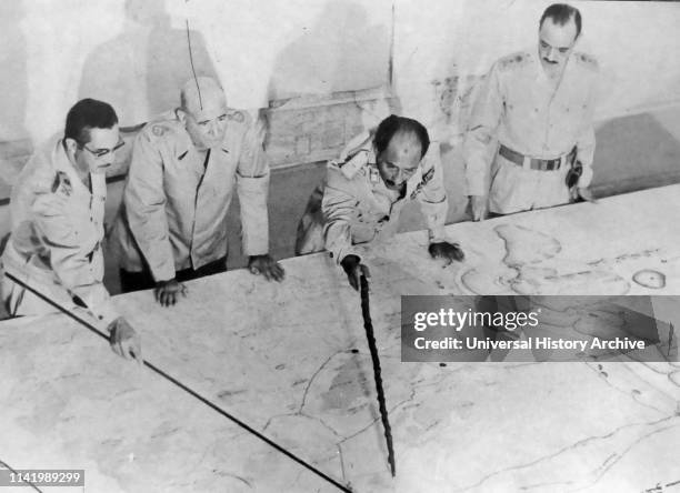 Anwar el-Sadat President of Egypt, at Military HQ during the 1973 Arab-Israeli War. He is accompanied by Field Marshall Ahmed Ismail and General...