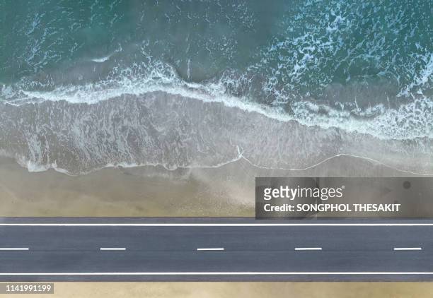 aerial view/the road along the beach by the sea with beautiful waves - swimming lane marker bildbanksfoton och bilder