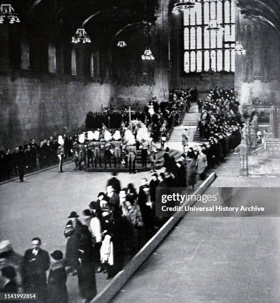 King George V lies in state in Westminster Hall, London as crowds pass his coffin. Funeral of King George V , King of the United Kingdom and the...