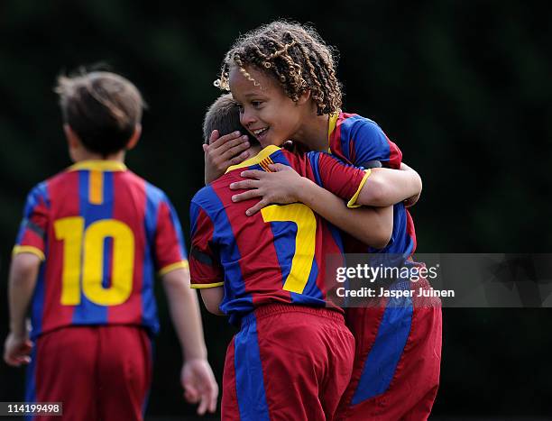 Eight-year-old Barcelona youth player Xavi Simons celebrates a goal with a teammate againts Llongueras on one of the pitches at the Joan Camper...